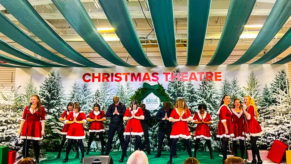 West End Kids performers on the Christmas Theatre stage at the Ideal Home Show